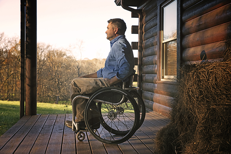 Man in a wheelchair alone on a porch